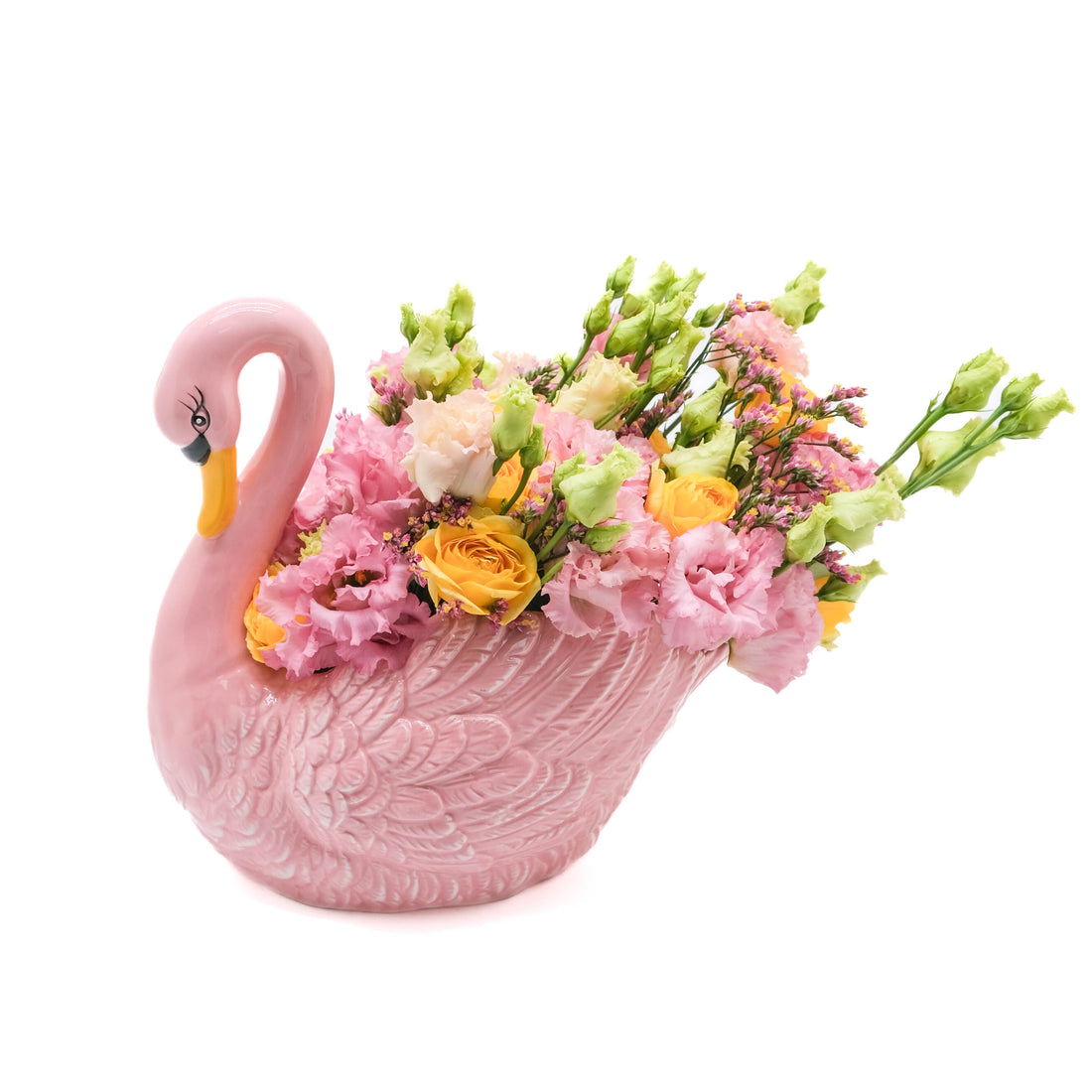 Pink swan-shaped vase filled with flowers on a white background