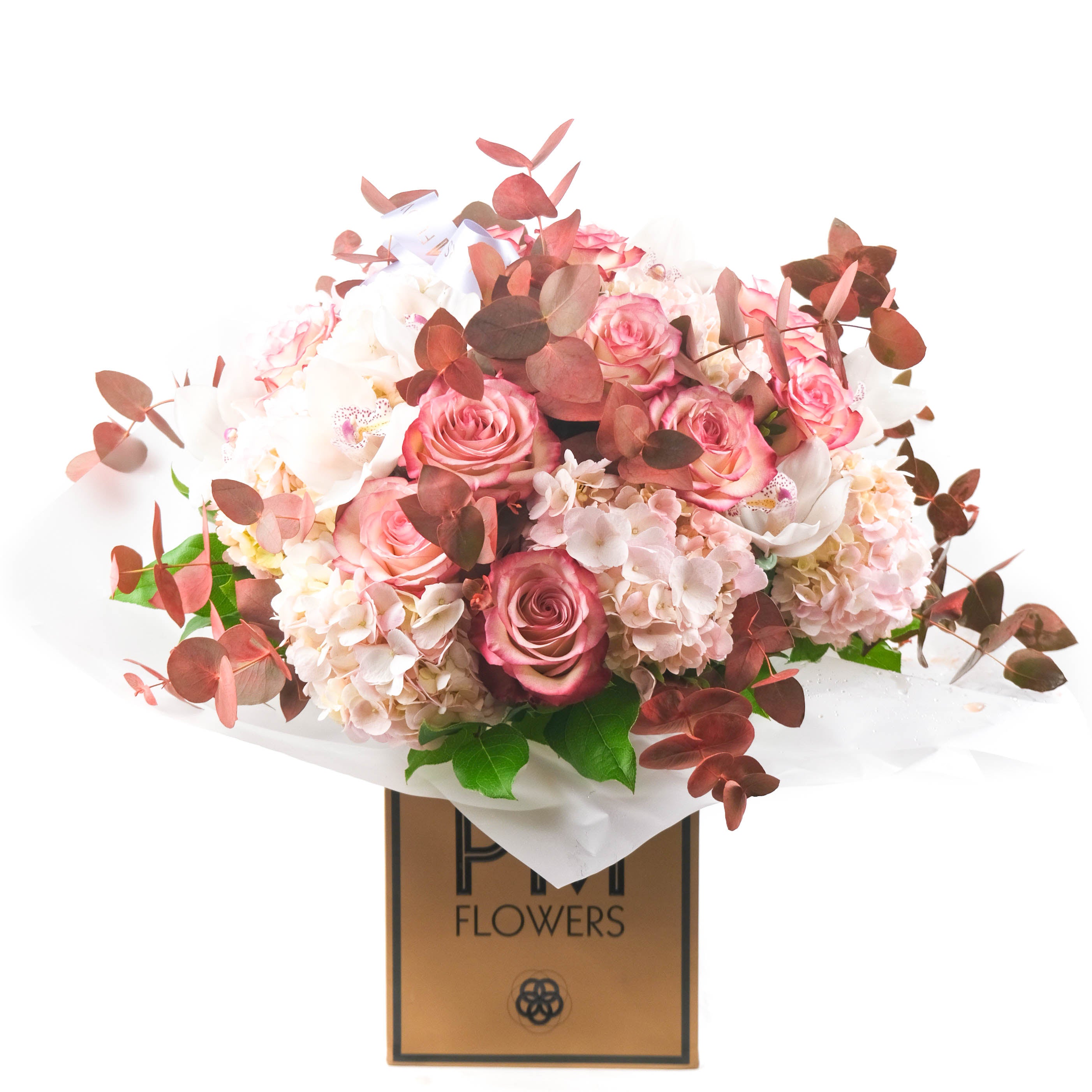 A bouquet of flowers including pink hydrangeas, Palmoma roses, and green foliage, arranged ias a bouquet with a PM Flowers label.