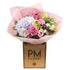A bouquet of flowers containing lilac hydrangea, blousy lilac/pink roses, pink lisianthus, astrantia, limonium, and orchid, wrapped in pink paper and presented in a box with &