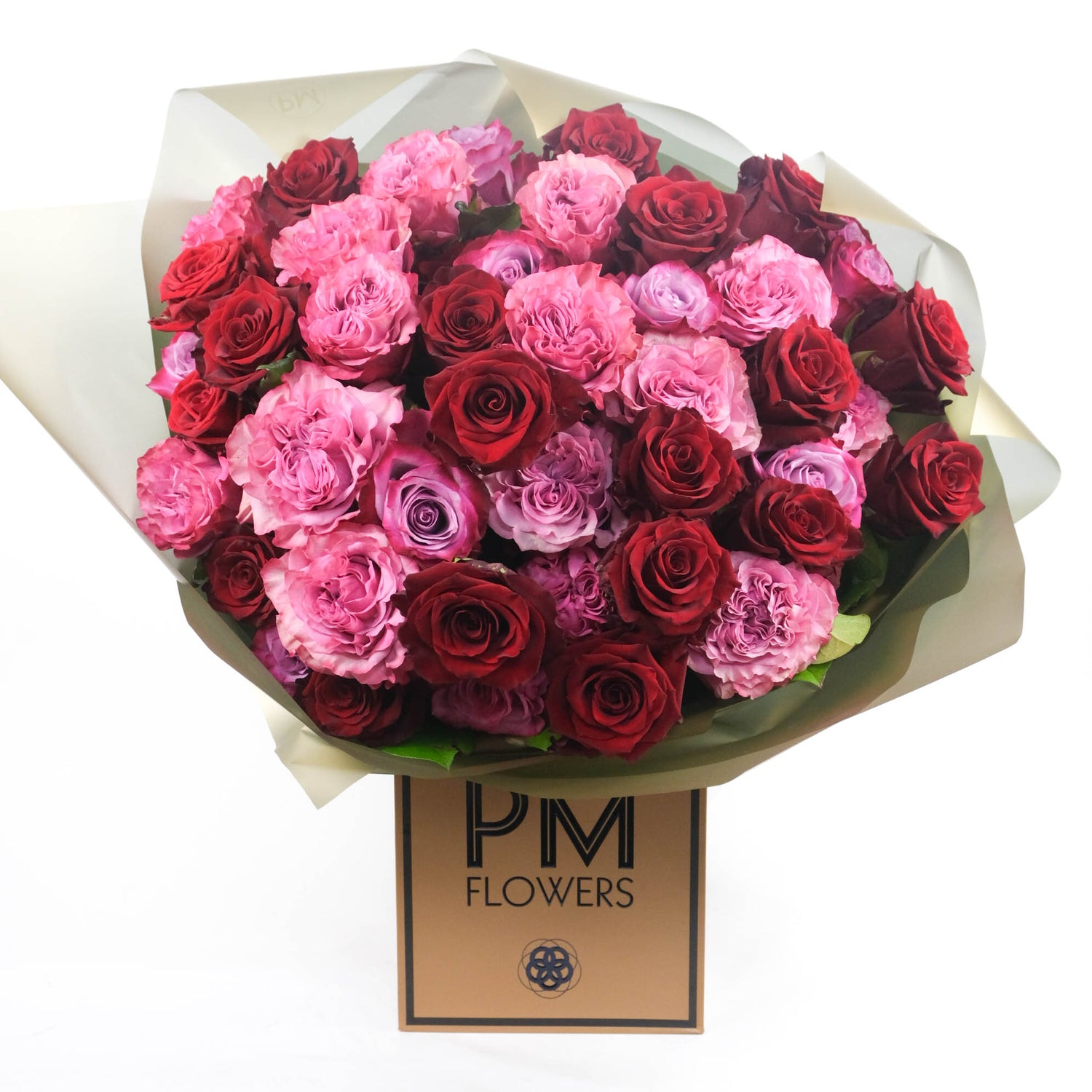 A bouquet of pink, red, and purple roses arranged 
