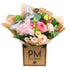 A bouquet of pink and peach flowers including roses and hydrangea, wrapped in a brown paper with a label that reads &