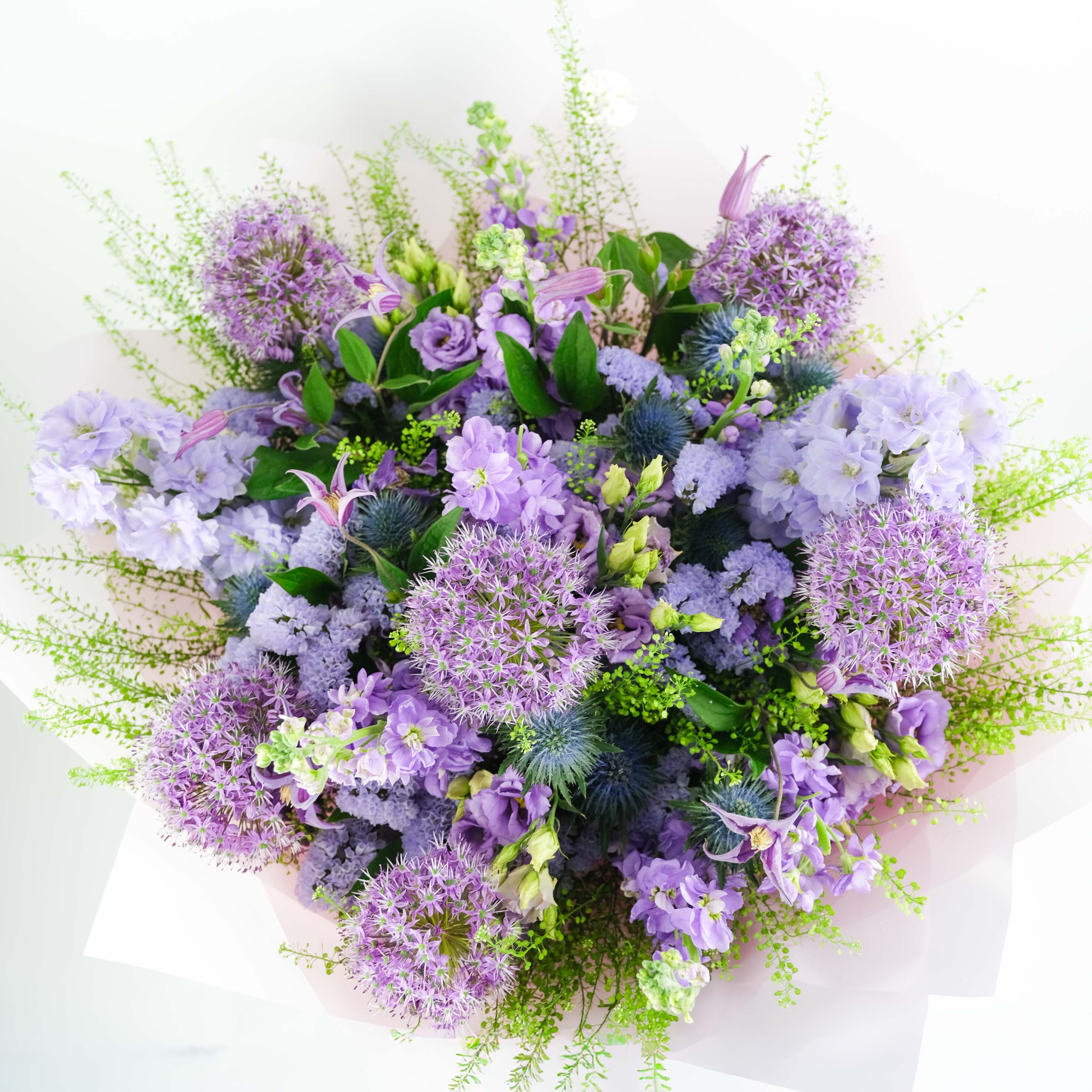 Bouquet of purple and green flowers on a white background