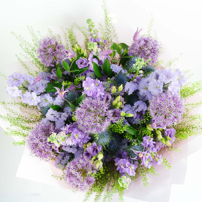 Bouquet of purple and green flowers on a white background