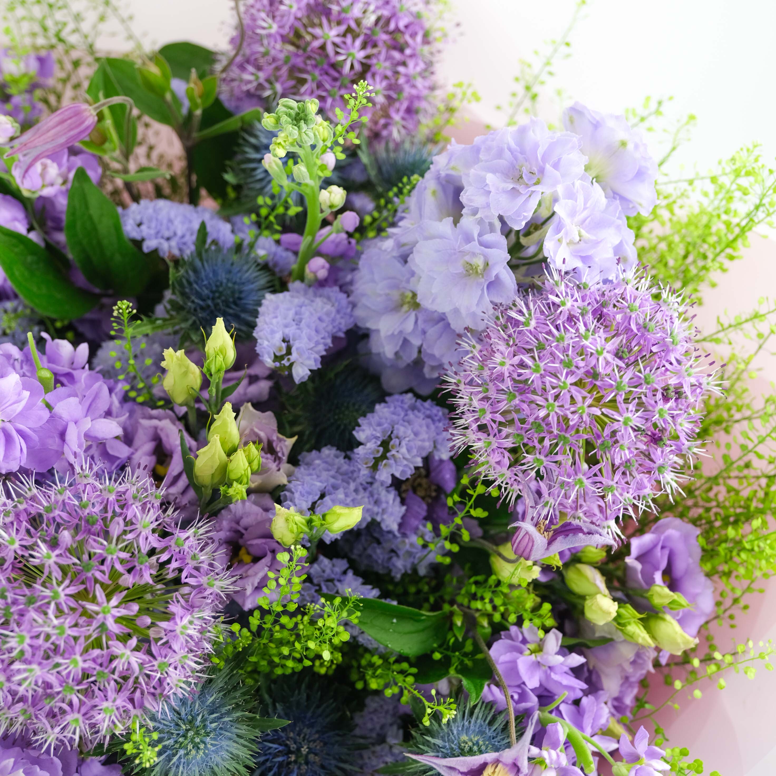Bouquet of purple and green flowers with a soft focus background