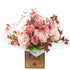 A bouquet of flowers including pink hydrangeas, Palmoma roses, and green foliage, arranged ias a bouquet with a PM Flowers label.